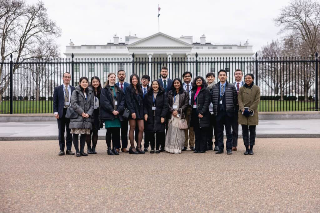 Group of Quad fellows stand outside the White House in Washington D.C.